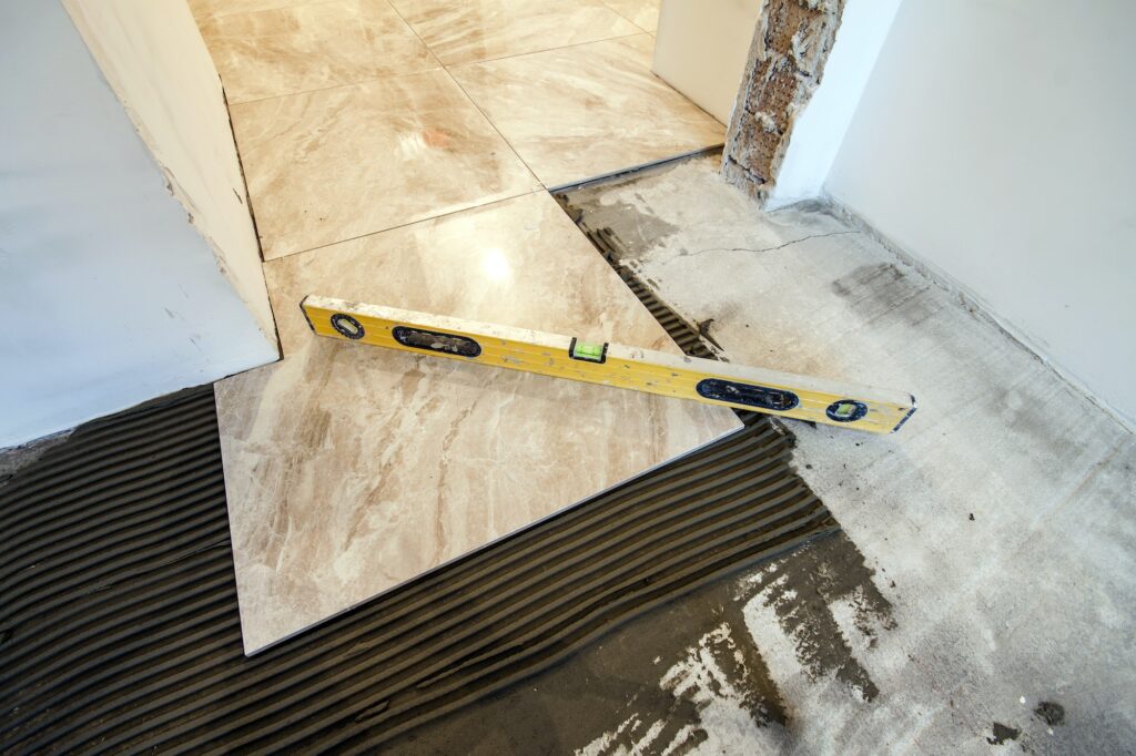 Ceramic tiles and tools for tiler. Floor tiles installation. Home improvement, renovation